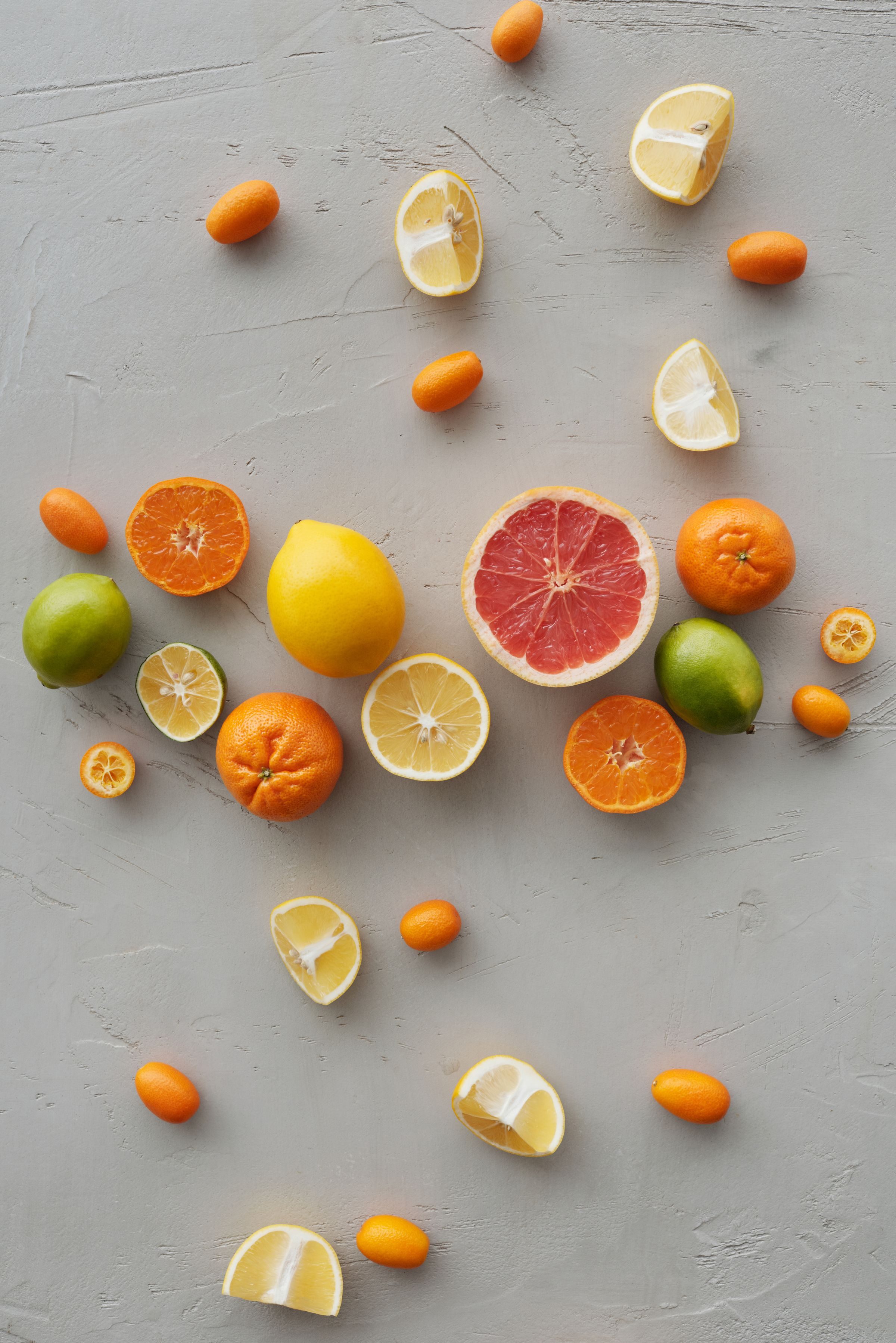 Flat lay of sliced citrus fruits — healthy-seeming foods whose acidity quietly erodes tooth enamel