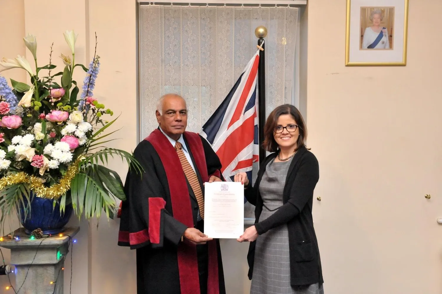 Dr Jacqueline Jacobs receiving her certificate of British citizenship at her UK citizenship ceremony.